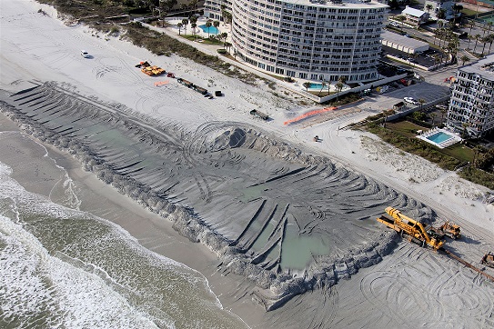 Overhead view of shore restoration project in Duval County, Florida. Image shows an area where new sand is being added to beach.